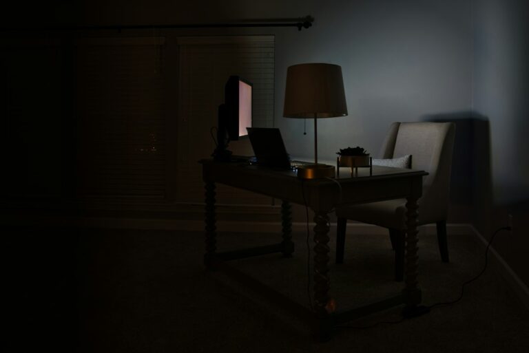 A dark desk setup with a laptop displaying a lock, illustrating ransomware